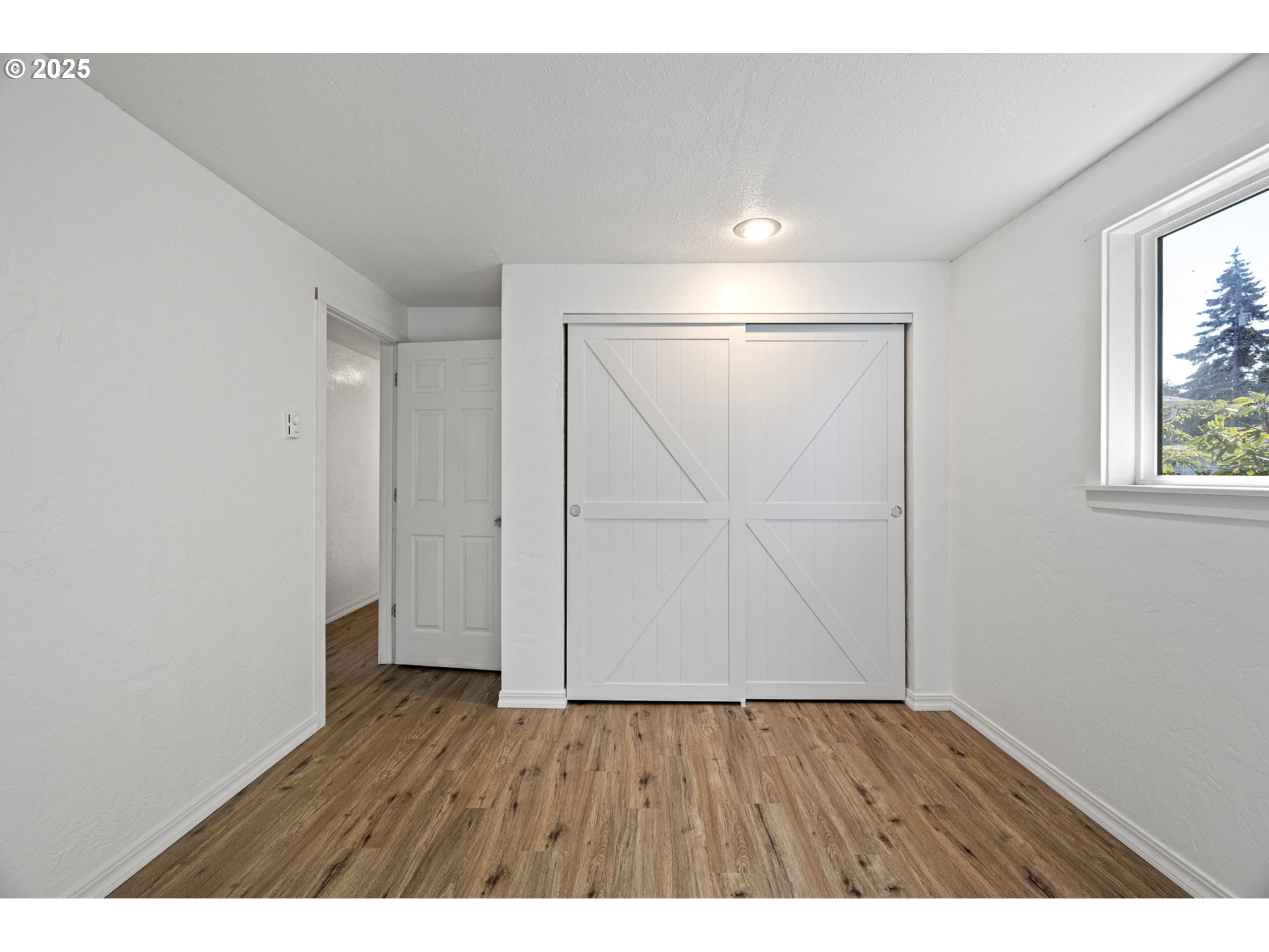 2105 16th Street Florence, OR 97439 - Photo 30 of 48 a view of an empty room with wooden floor and a window