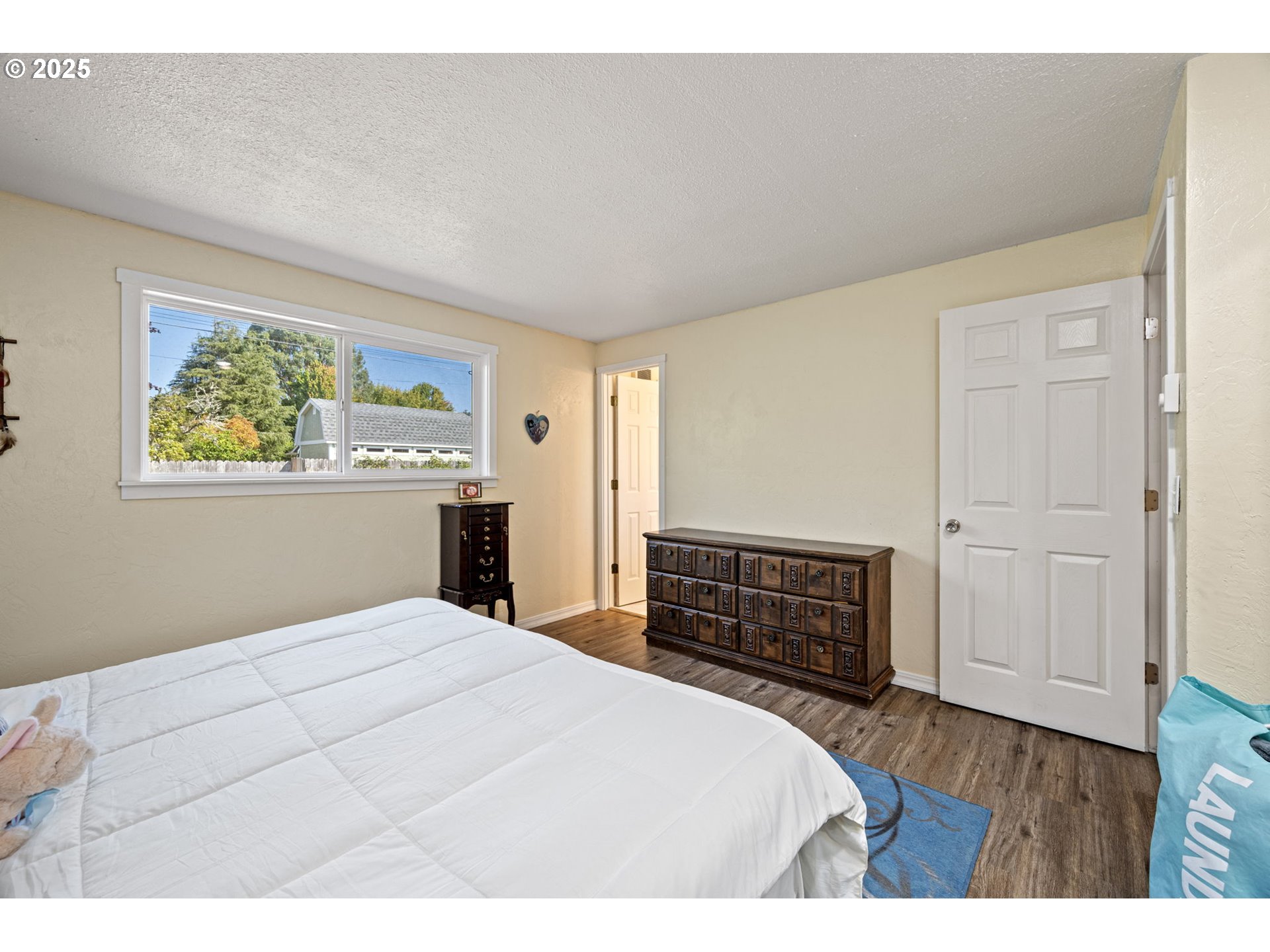 2105 16th Street Florence, OR 97439 - Photo 33 of 48 a bedroom with a bed and a dresser