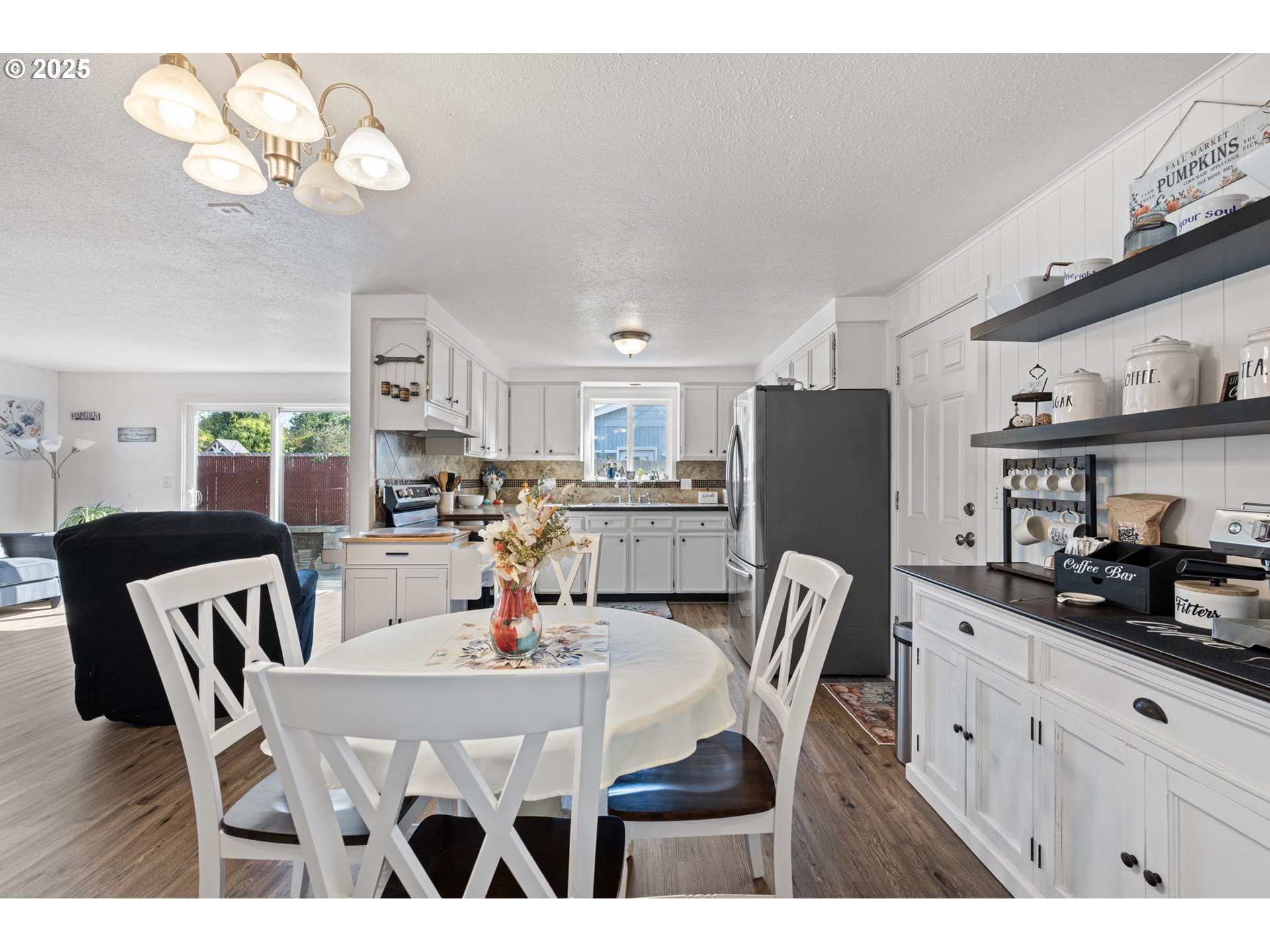 2105 16th Street Florence, OR 97439 - Photo 4 of 48 a kitchen with stainless steel appliances granite countertop a dining table chairs and a refrigerator
