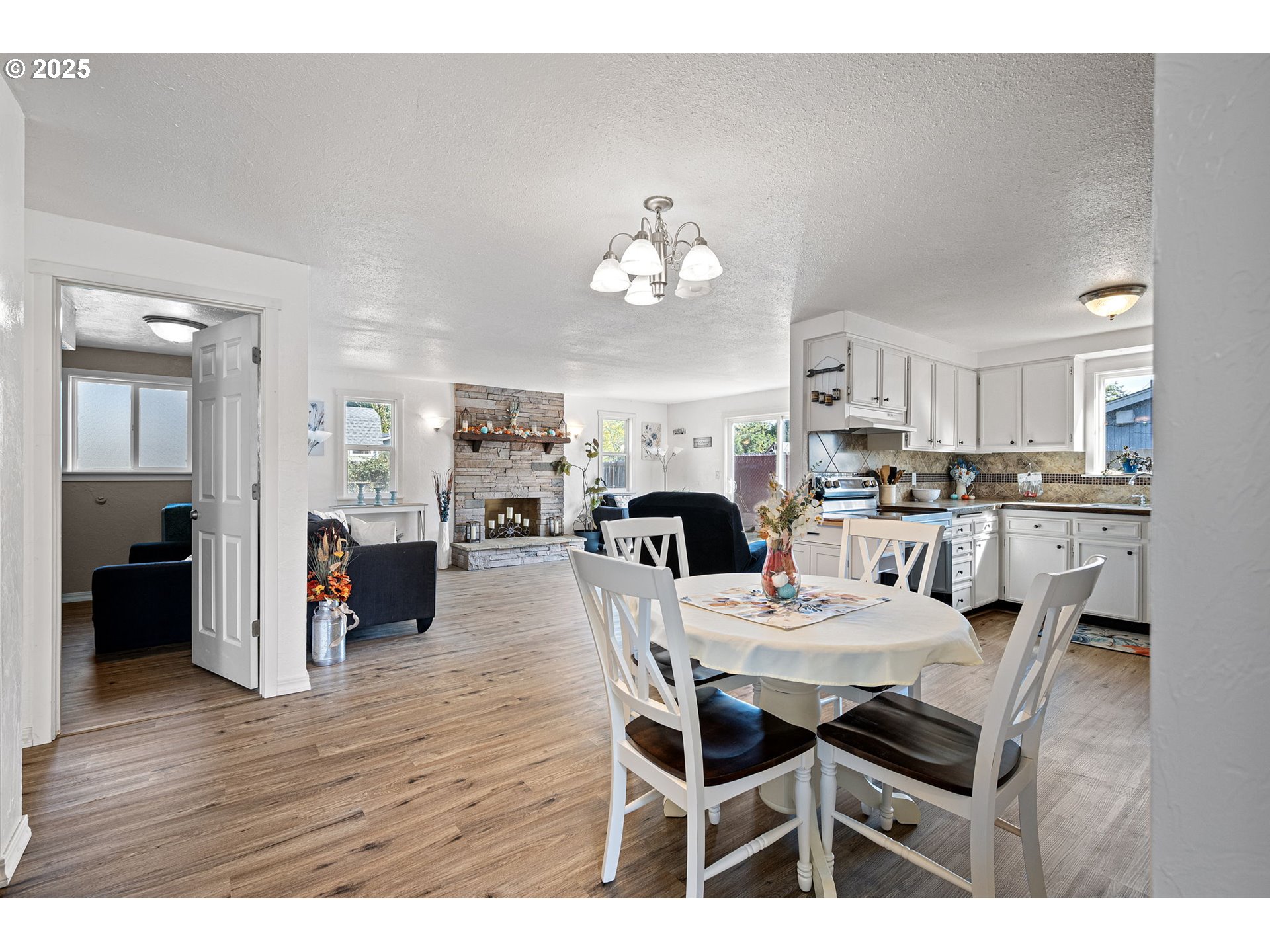 2105 16th Street Florence, OR 97439 - Photo 5 of 48 a view of a dining room with furniture and wooden floor