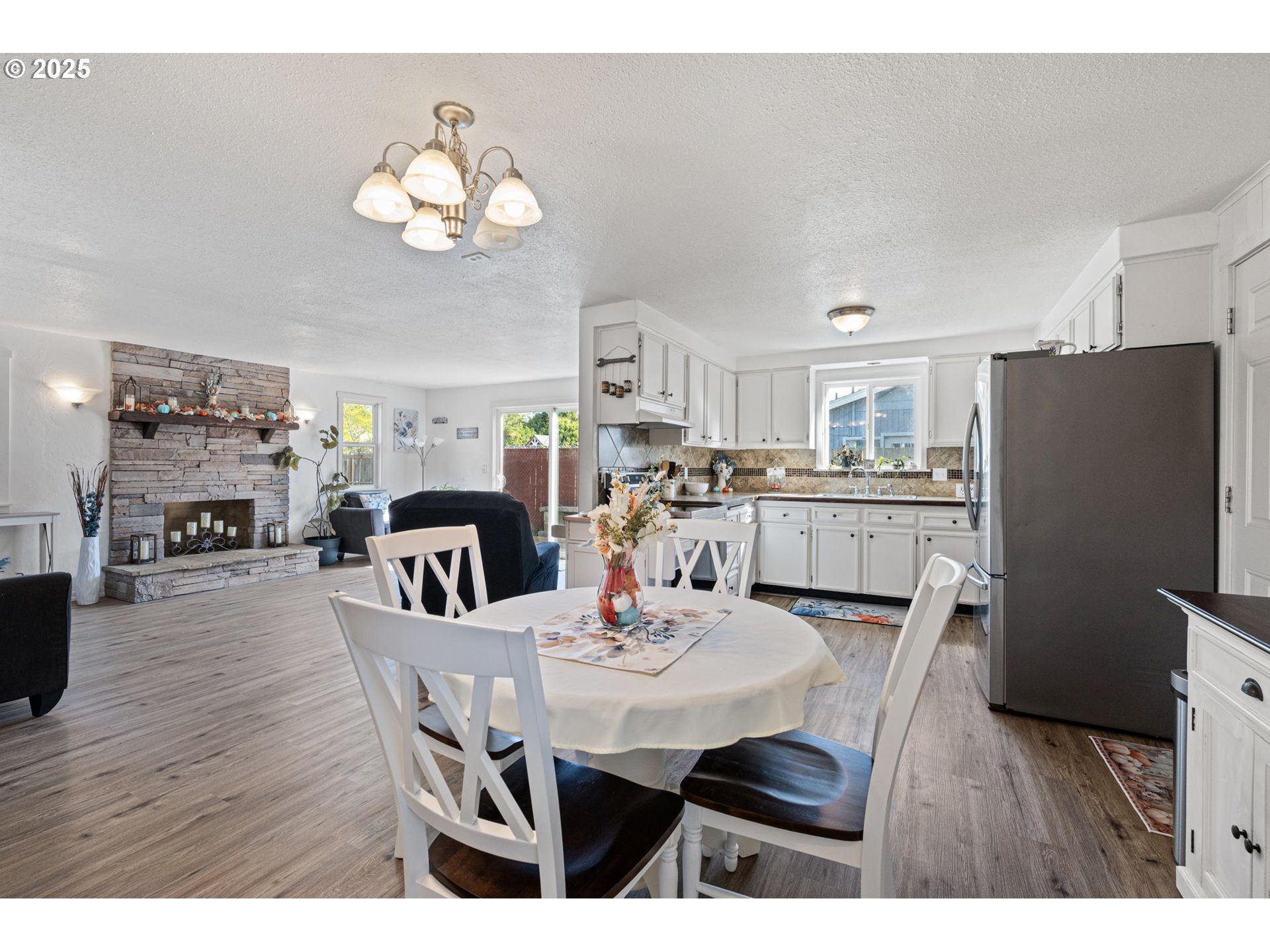 2105 16th Street Florence, OR 97439 - Photo 8 of 48 a view of a dining room with furniture and a chandelier