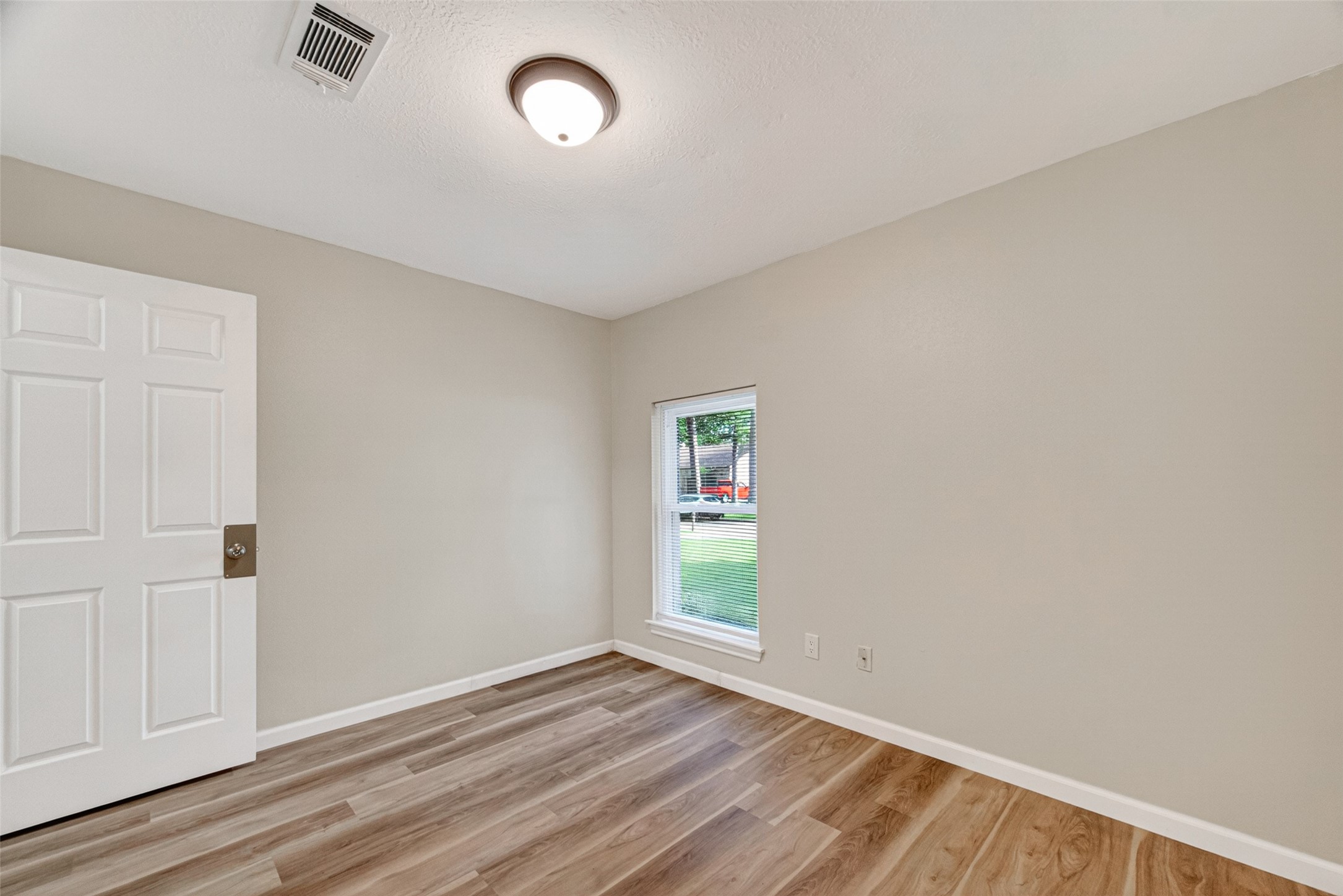 25503 Foxbriar Lane Spring, TX 77373 - Photo 23 of 45 an empty room with wooden floor and windows