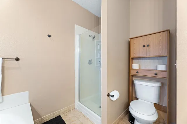 a bathroom with a toilet a sink and shower