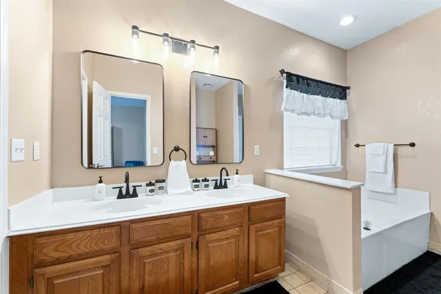 a bathroom with a double vanity sink mirror and