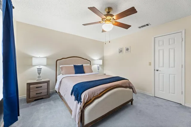 a bedroom with a bed and a ceiling fan