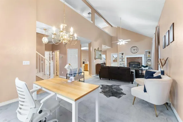 a living room with furniture a large mirror and a chandelier