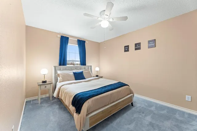 a bedroom with a bed and a ceiling fan