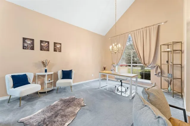 a living room with furniture a rug and a table