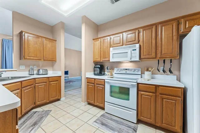 a kitchen with stainless steel appliances granite countertop a stove sink and cabinets