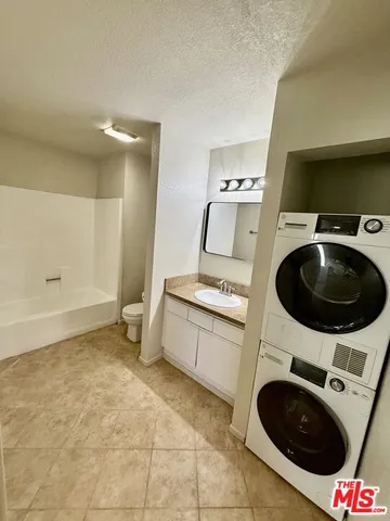 a utility room with sink dryer and washer