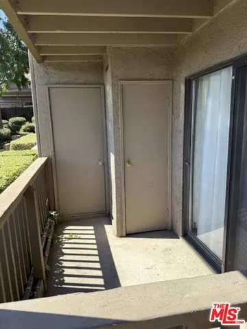 a view of a door and wooden floor