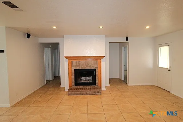 a view of an empty room with a fireplace