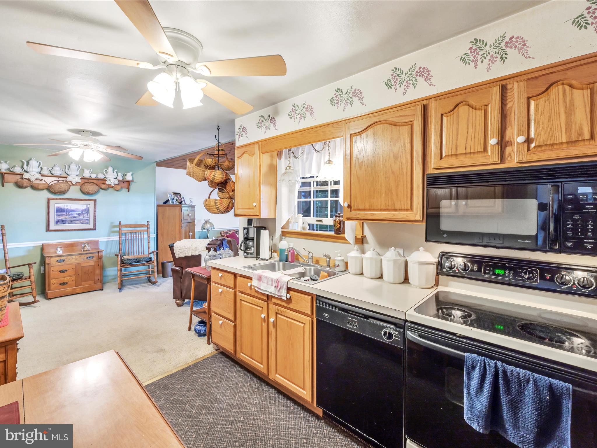 321 Wolf Creek Road Bernville, PA 19506 - Photo 18 of 49 a kitchen with stainless steel appliances a sink stove and cabinets