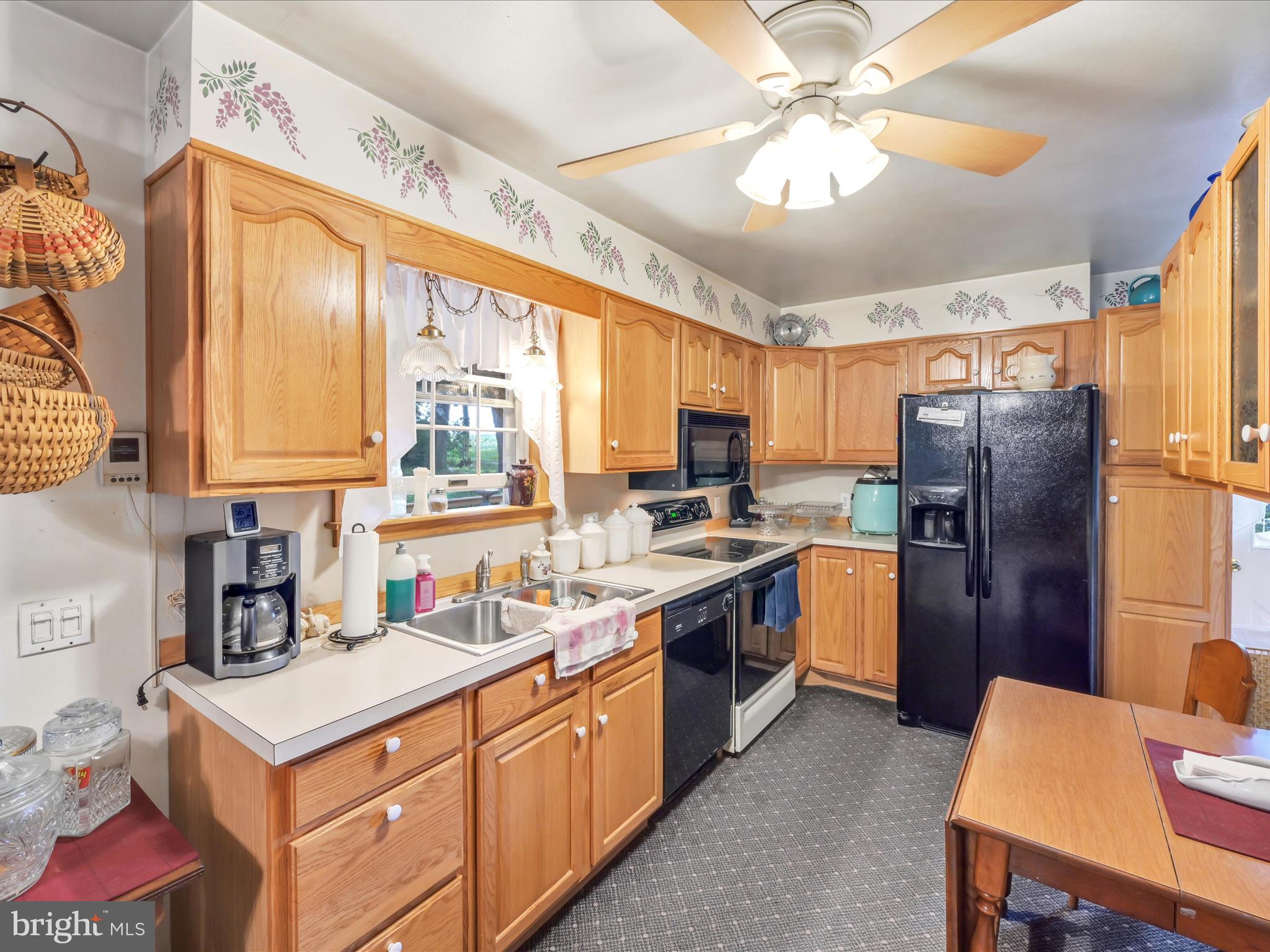 321 Wolf Creek Road Bernville, PA 19506 - Photo 21 of 49 a kitchen with a sink stove and refrigerator
