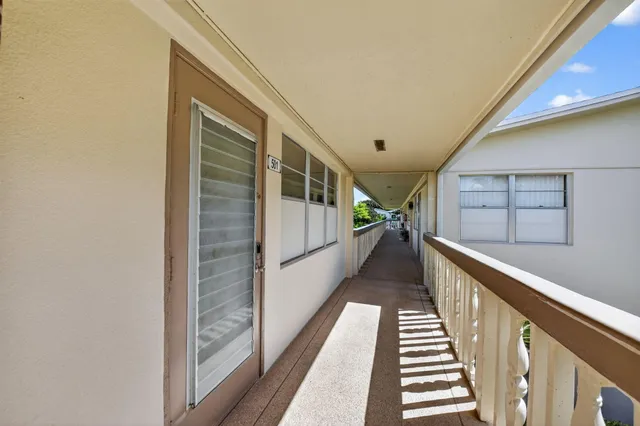 an aerial view of a house with a garden and lake view
