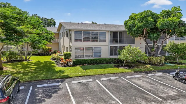 an aerial view of residential houses with outdoor space and swimming pool