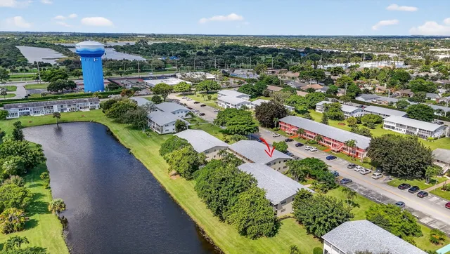 a living room with furniture and a dining table with kitchen view