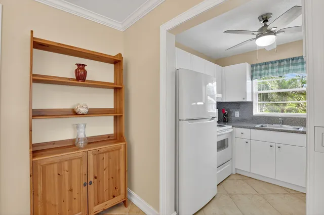 a kitchen with stainless steel appliances a sink cabinets and a window