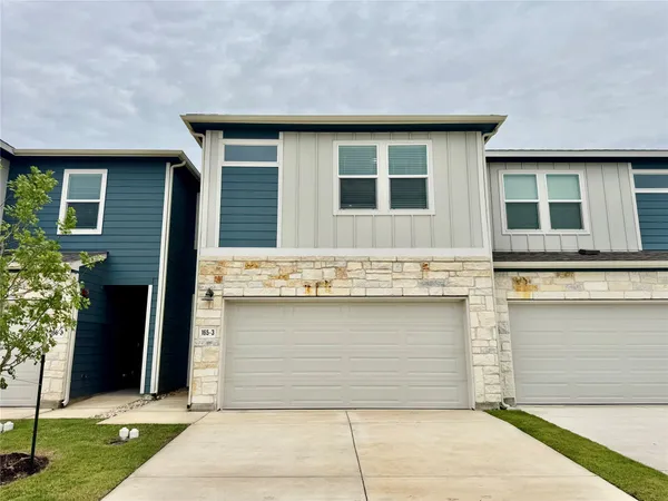 a front view of a house with garage