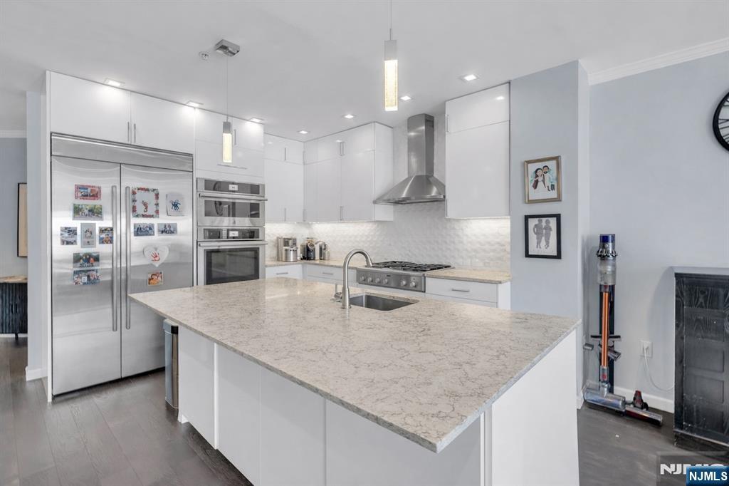 a kitchen with stainless steel appliances granite countertop a sink refrigerator and microwave
