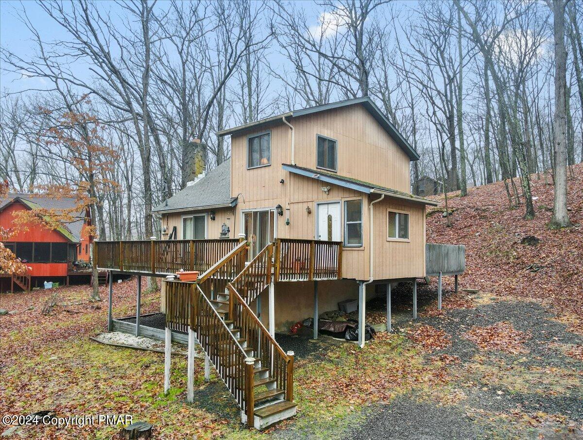 188 Canterbury Road Bushkill, PA 18324 - Photo 3 of 40 a white house that has a table and chairs in it