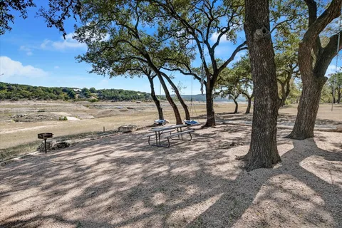 a view of a lake with lawn chairs