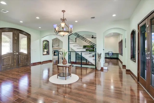 a view of a dining room with furniture a chandelier and wooden floor