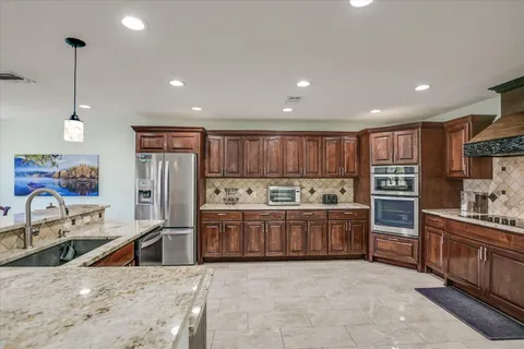 a kitchen with lots of counter top space and appliances