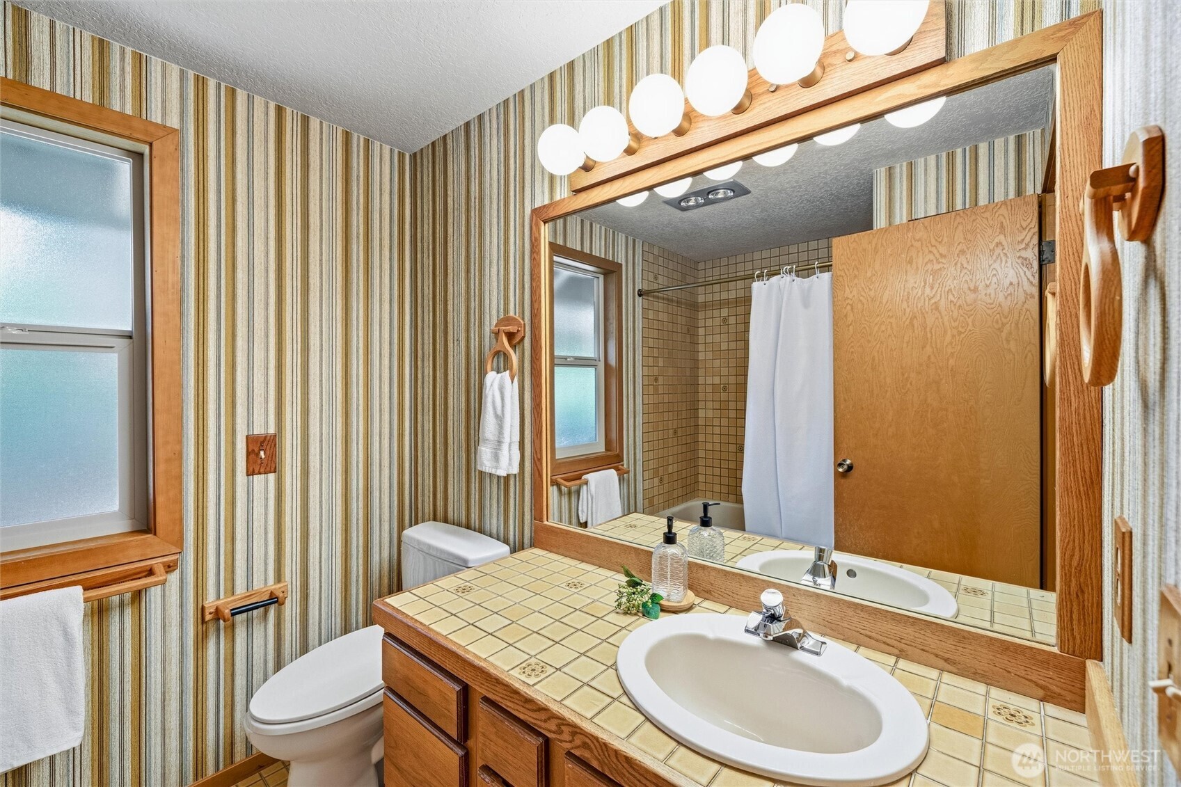 601 Clark Road Bellingham, WA 98225 - Photo 21 of 38 a bathroom with a sink a toilet and a mirror