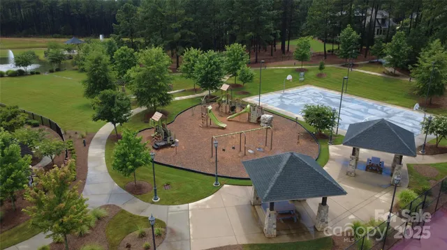 an aerial view of a house with outdoor space and lake view
