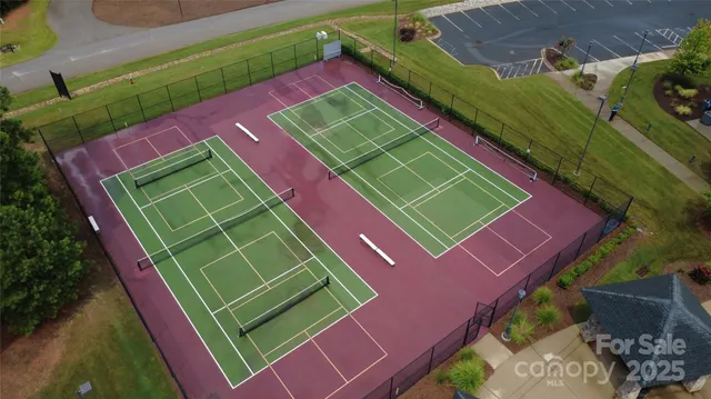 a green field with lots of trees