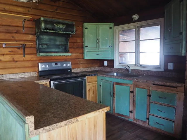 a kitchen with a stove a sink and a refrigerator