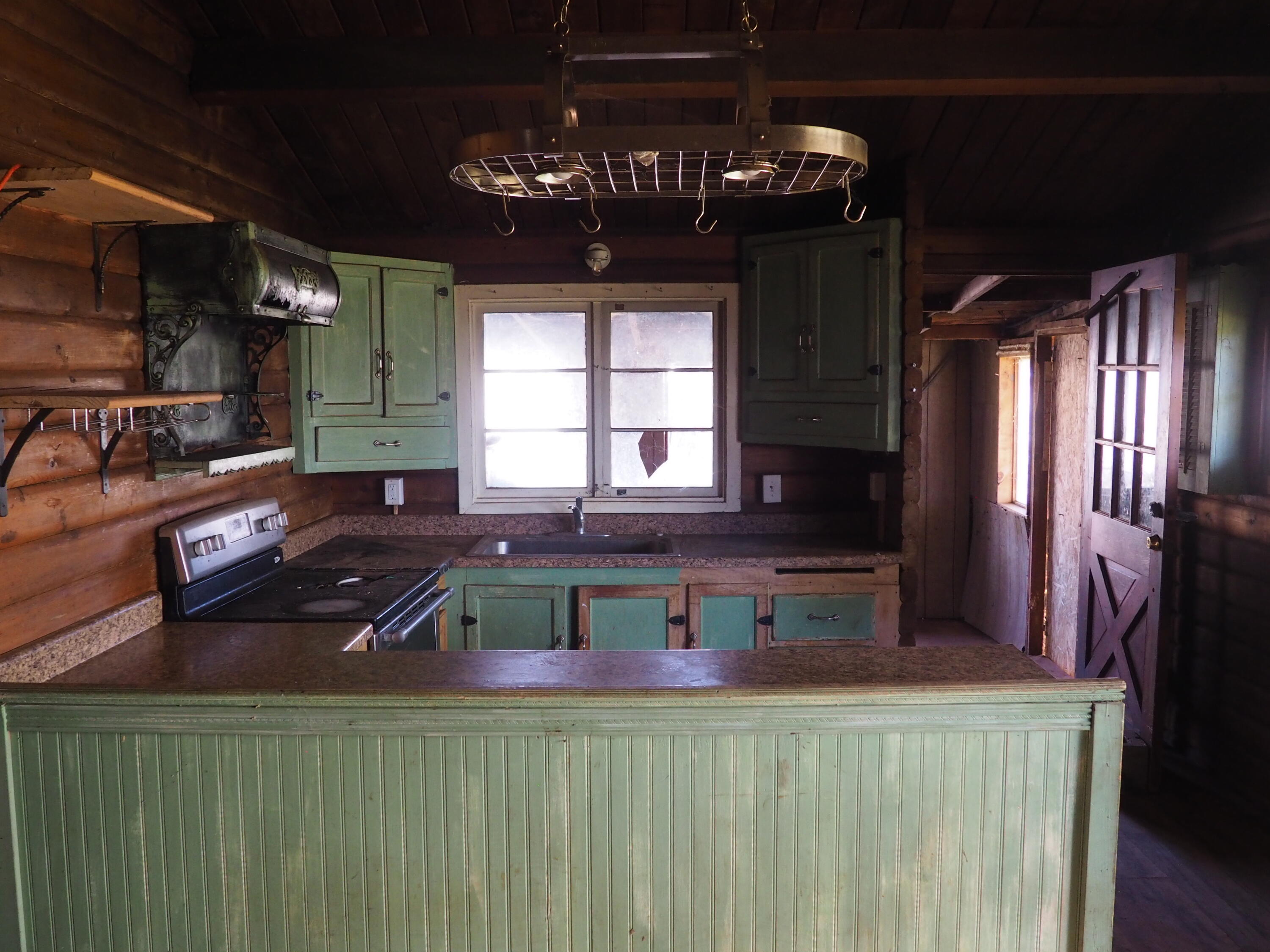 21705 South Powerhouse Road Manton, CA 96059 - Photo 9 of 15 a kitchen with a stove a sink and a refrigerator