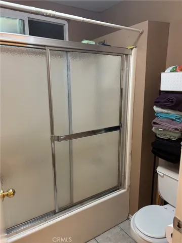 a bathroom with a shower and a toilet