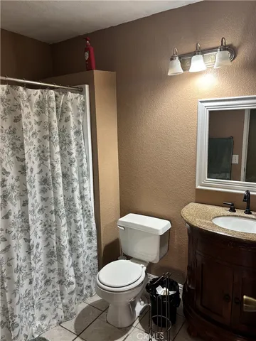 a bathroom with a toilet a sink and a mirror