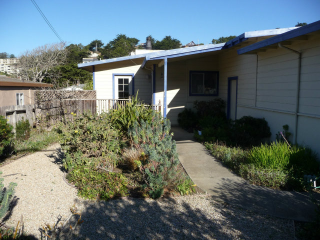 441 Brighton Road Pacifica, CA 94044 - Photo 3 of 18 a front view of a house with a yard