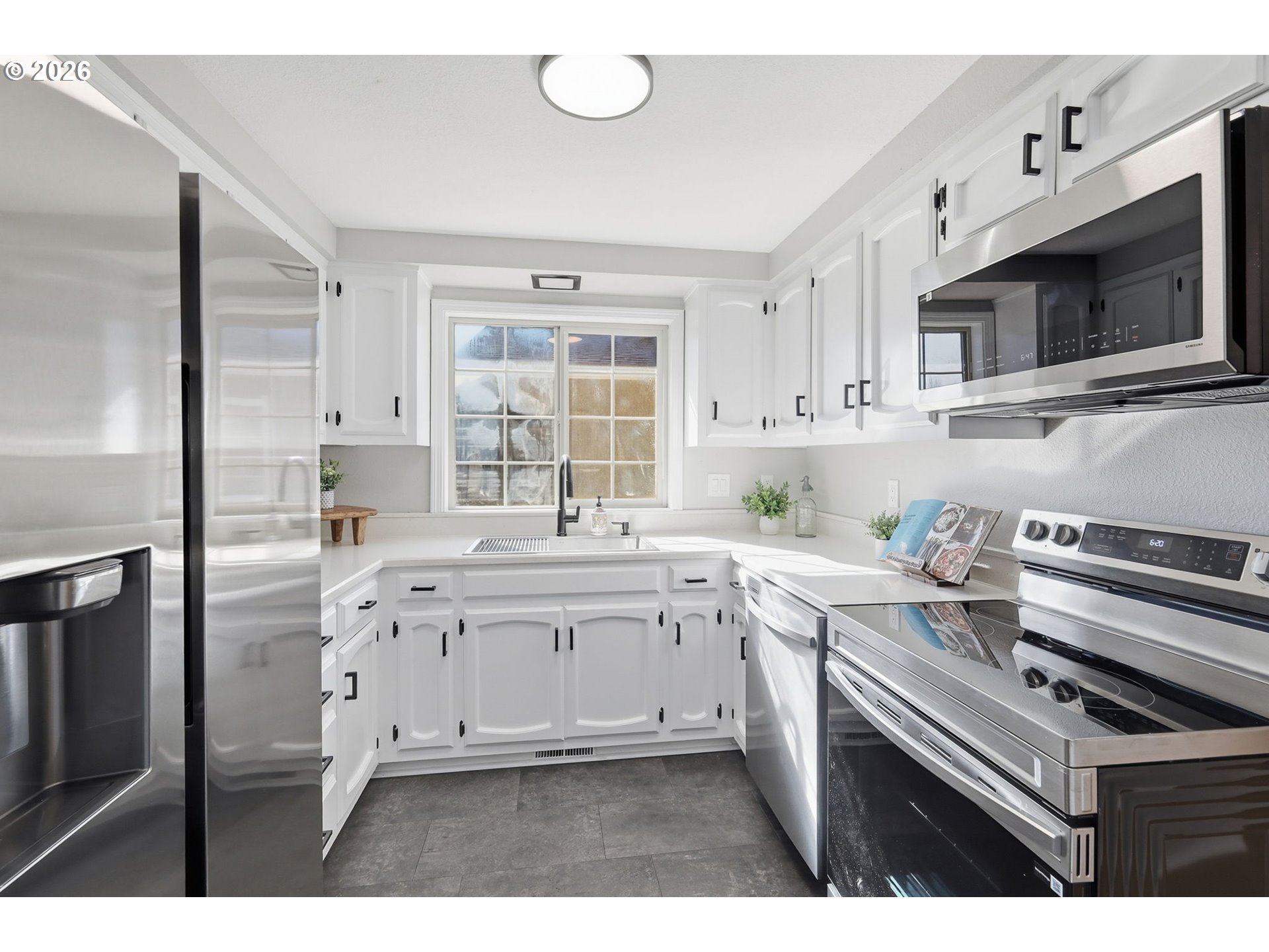 1467 South 7th Street Cottage Grove, OR 97424 - Photo 16 of 48 a kitchen with stainless steel appliances a stove microwave and cabinets