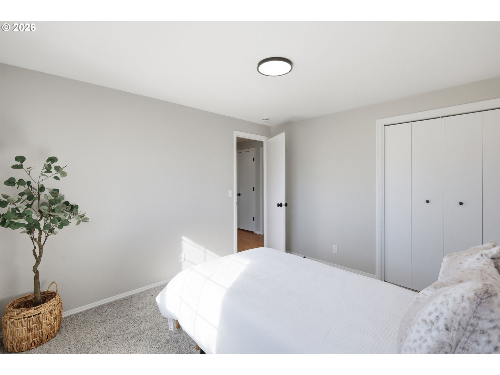 1467 South 7th Street Cottage Grove, OR 97424 - Photo 22 of 48 a bedroom with a bed and a potted plant