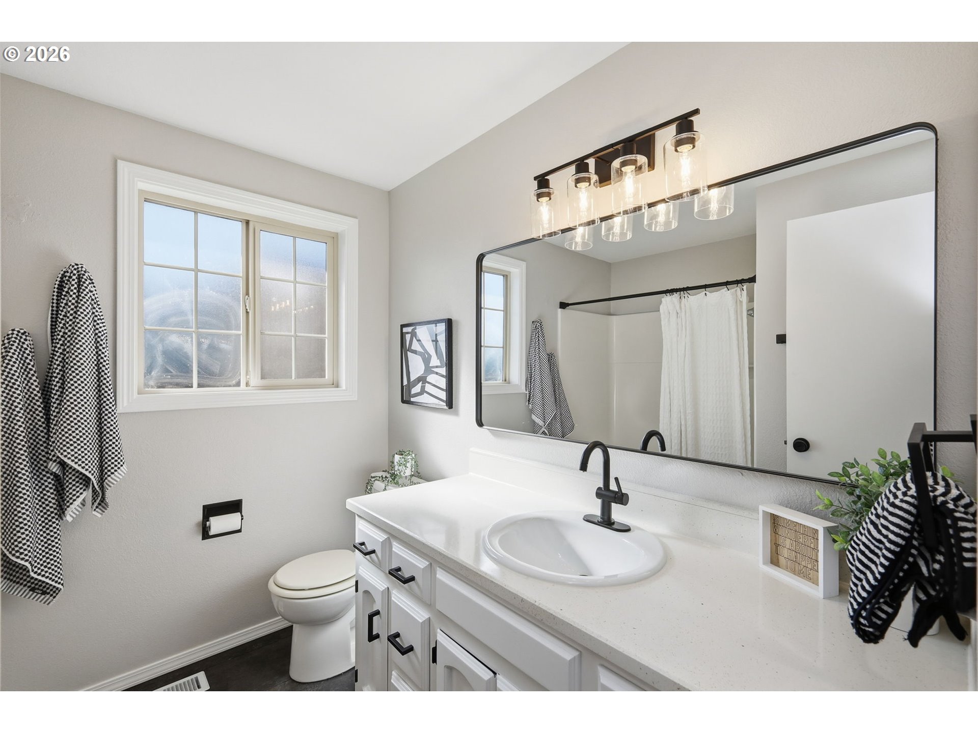 1467 South 7th Street Cottage Grove, OR 97424 - Photo 23 of 48 a bathroom with a sink a toilet and a mirror