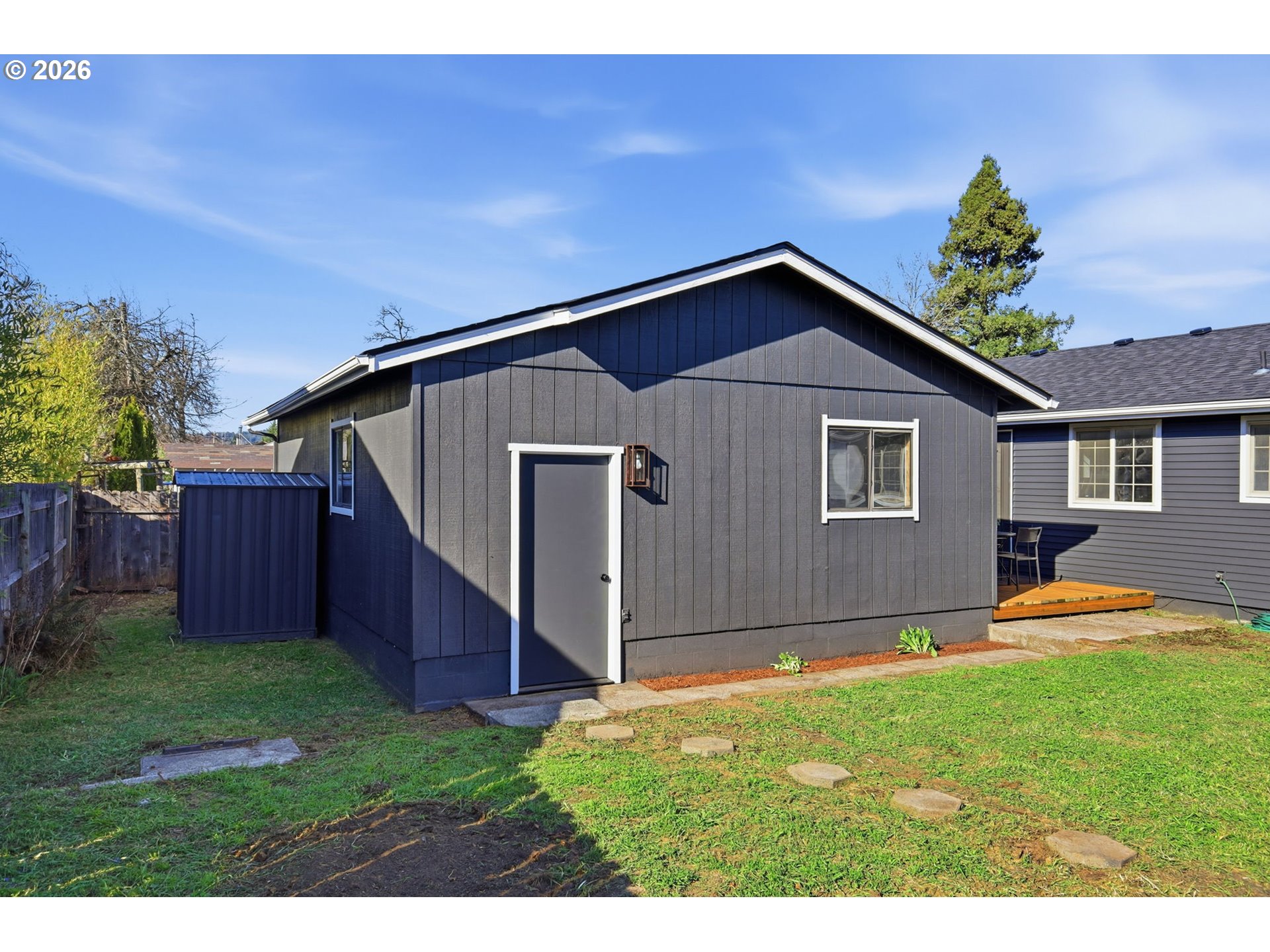 1467 South 7th Street Cottage Grove, OR 97424 - Photo 36 of 48 a backyard of a house with wooden fence and large trees