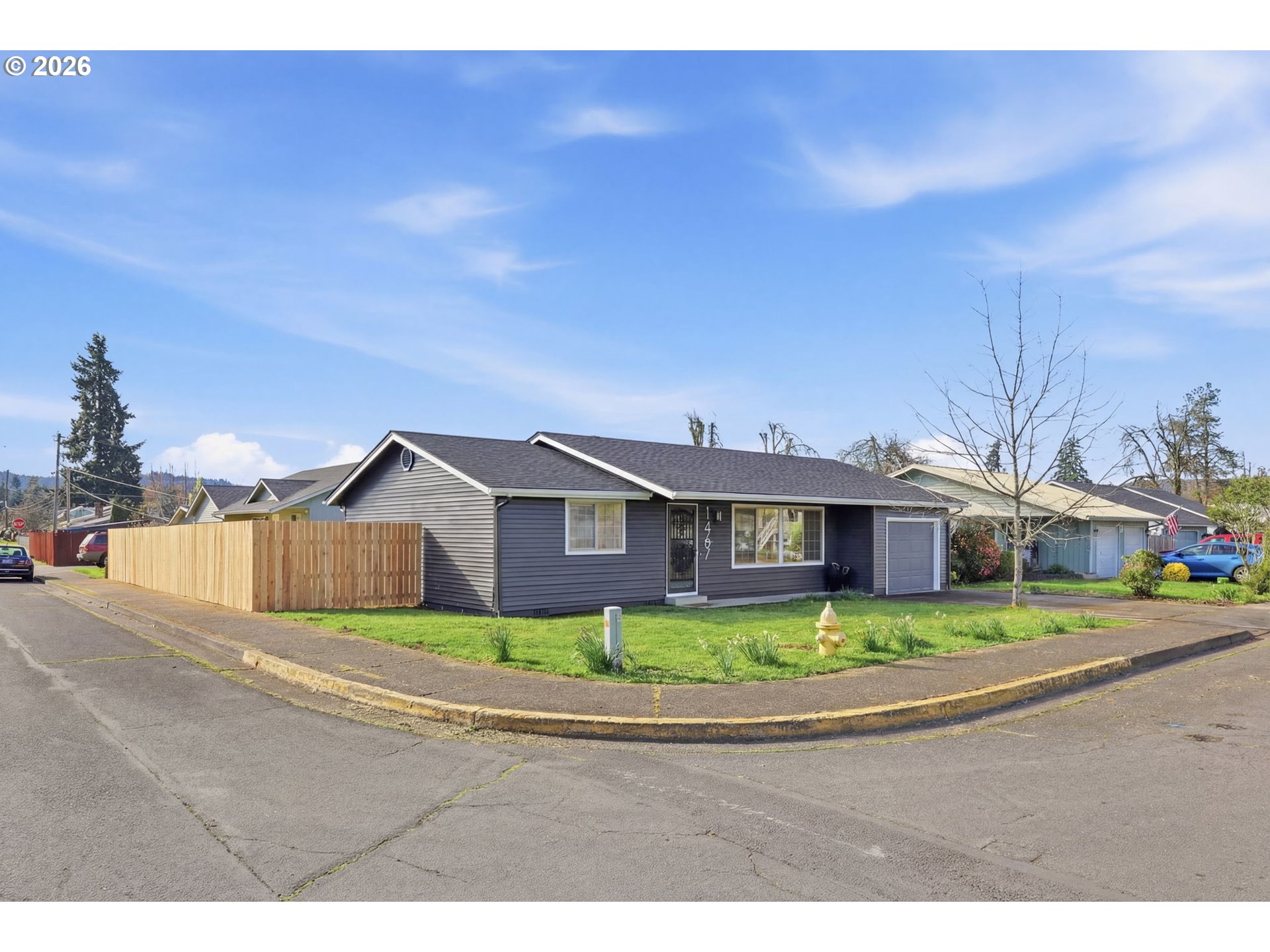 1467 South 7th Street Cottage Grove, OR 97424 - Photo 42 of 48 a front view of a house with a garden and yard