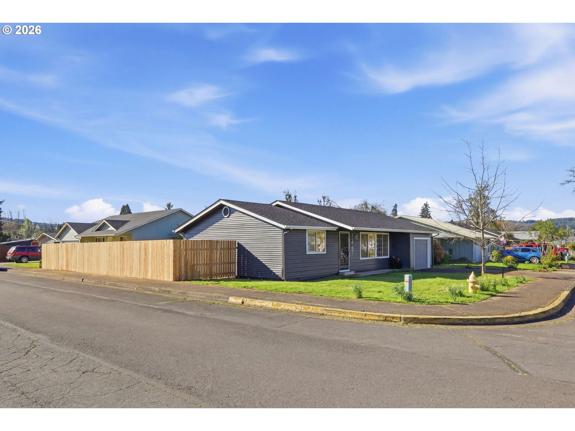 1467 South 7th Street Cottage Grove, OR 97424 - Photo 43 of 48 a front view of a house with a garden and yard