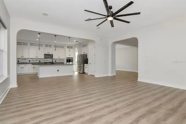 a view of kitchen with stainless steel appliances refrigerator stove microwave and cabinets