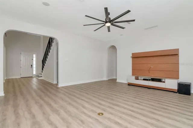 a kitchen with stainless steel appliances granite countertop a sink a stove and a wooden floors