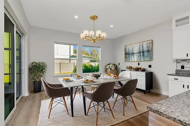 a bathroom with a granite countertop bathtub sink vanity mirror and toilet