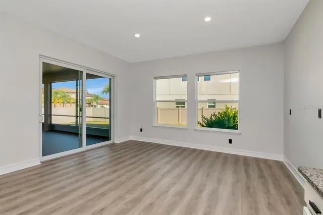 a view of a hallway with wooden floor and stairs