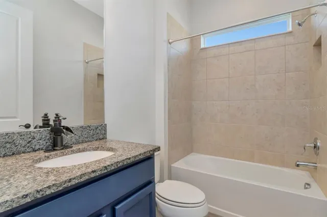 a bedroom with bed and a couch