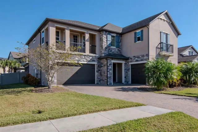 a front view of a house with a yard and garage