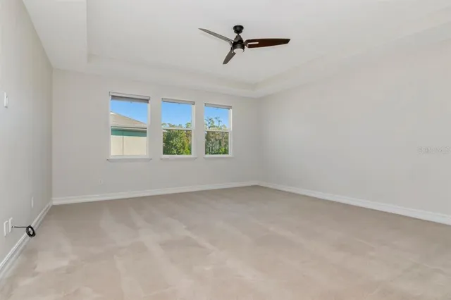 a bathroom with a granite countertop bathtub sink vanity mirror and toilet
