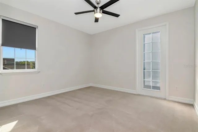 a living room with yard view and a floor to ceiling window